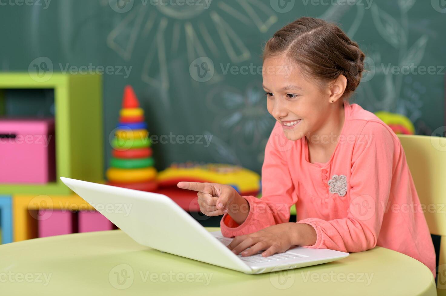 Portrait of girl studing with laptop at classroom photo