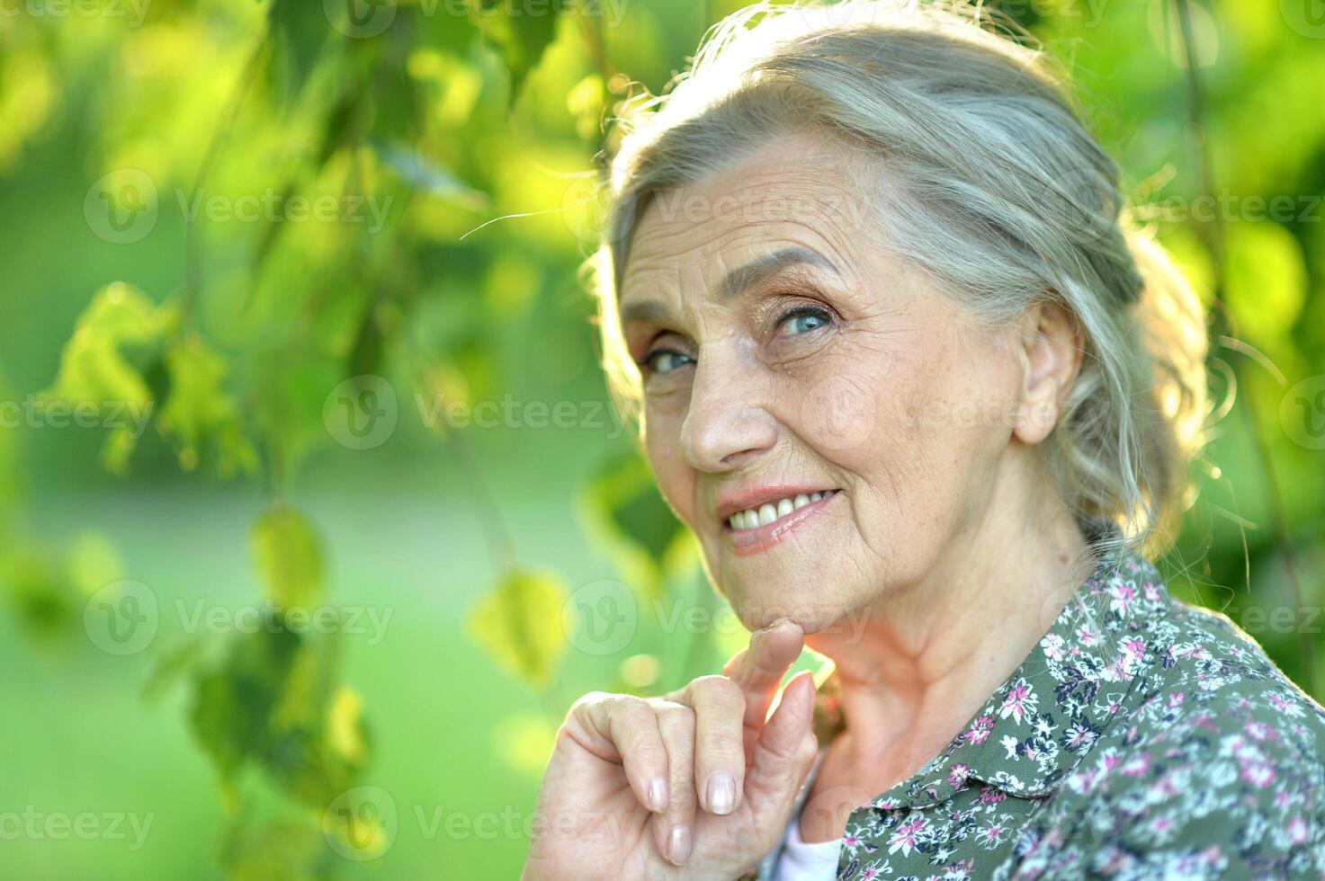 Portrait of a beautiful woman in the park in summer photo