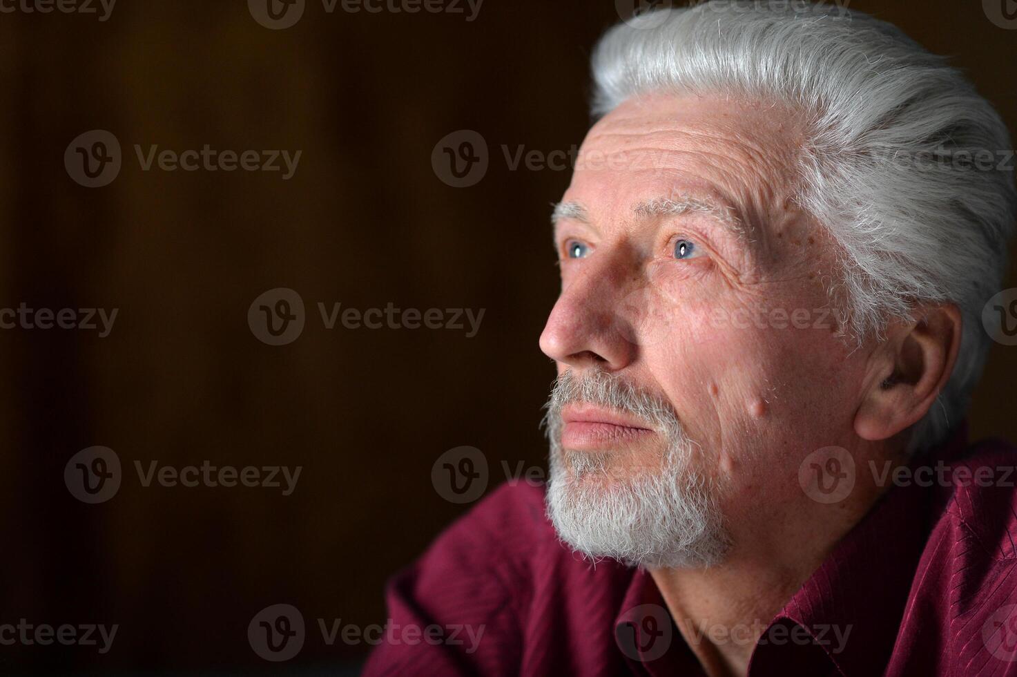 close-up portrait of a senior man thinking about something photo