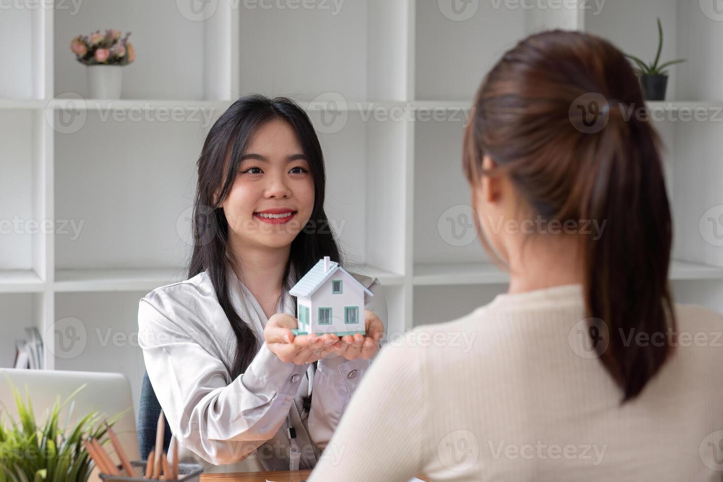 Home sales and real estate agent provide home models to clients to complete sale contract with. photo