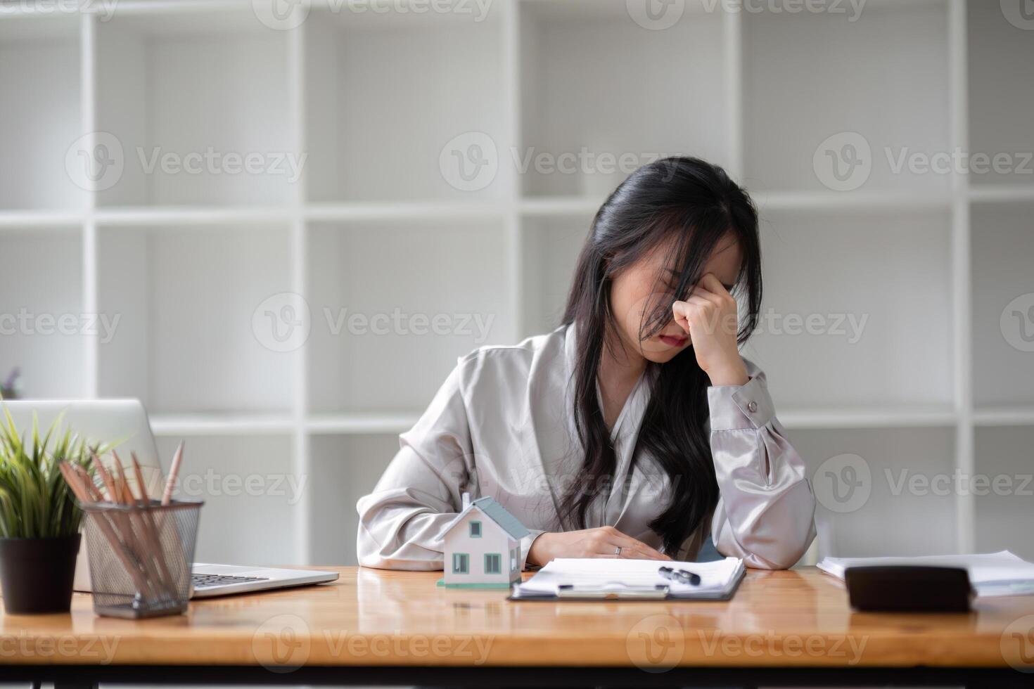 businesswoman feeling stressed by calculating numbers Calculate profits and taxes for clients with the calculator. photo