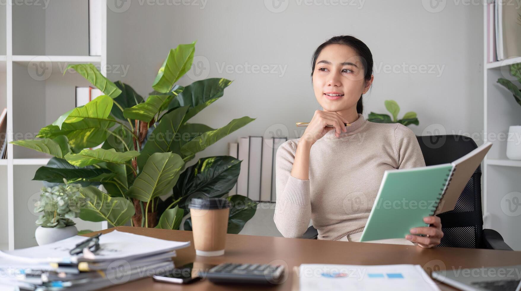 Young Asian student studies online about graphs and statistics. Happy Zoom call studying with laptop computer photo