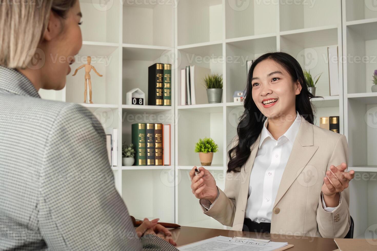 A young lawyer and businesswoman are discussing legal advice on signing a business contract. Insurance or financial contract signing photo