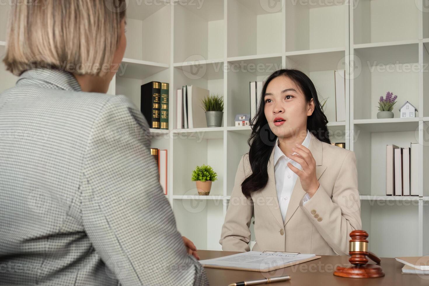 A young lawyer and businesswoman are discussing legal advice on signing a business contract. Insurance or financial contract signing photo