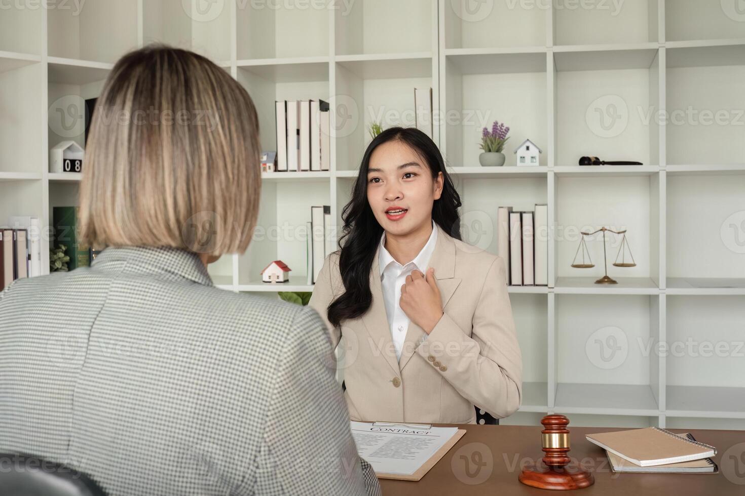 A young lawyer and businesswoman are discussing legal advice on signing a business contract. Insurance or financial contract signing photo