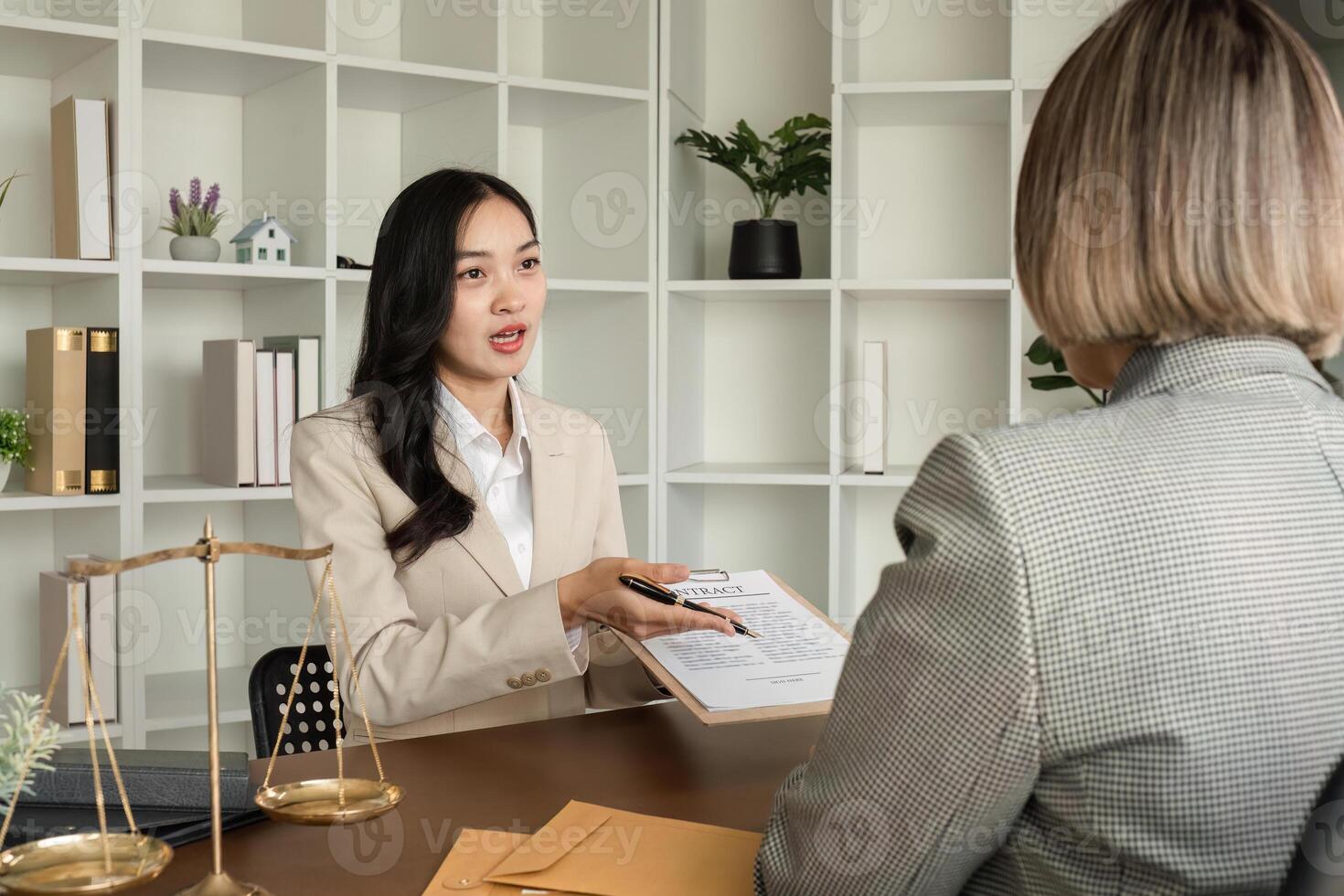 Lawyer and businesswomen discussing and introducing Providing legal advice regarding signing insurance contracts or financial contracts photo