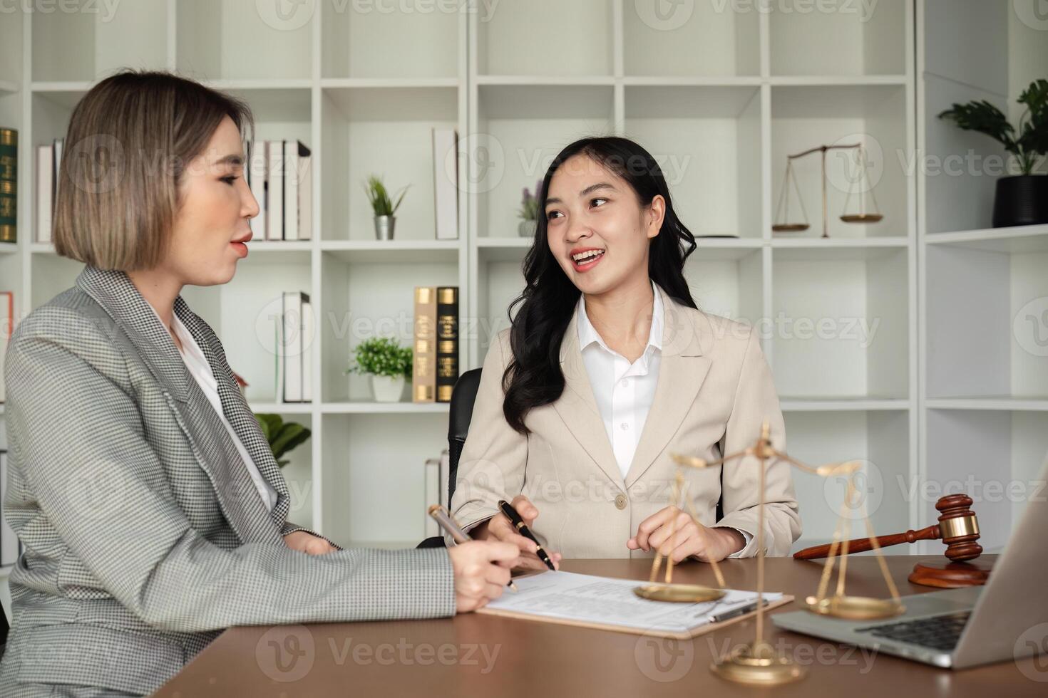 Lawyer and businesswomen discussing and introducing Providing legal advice regarding signing insurance contracts or financial contracts photo