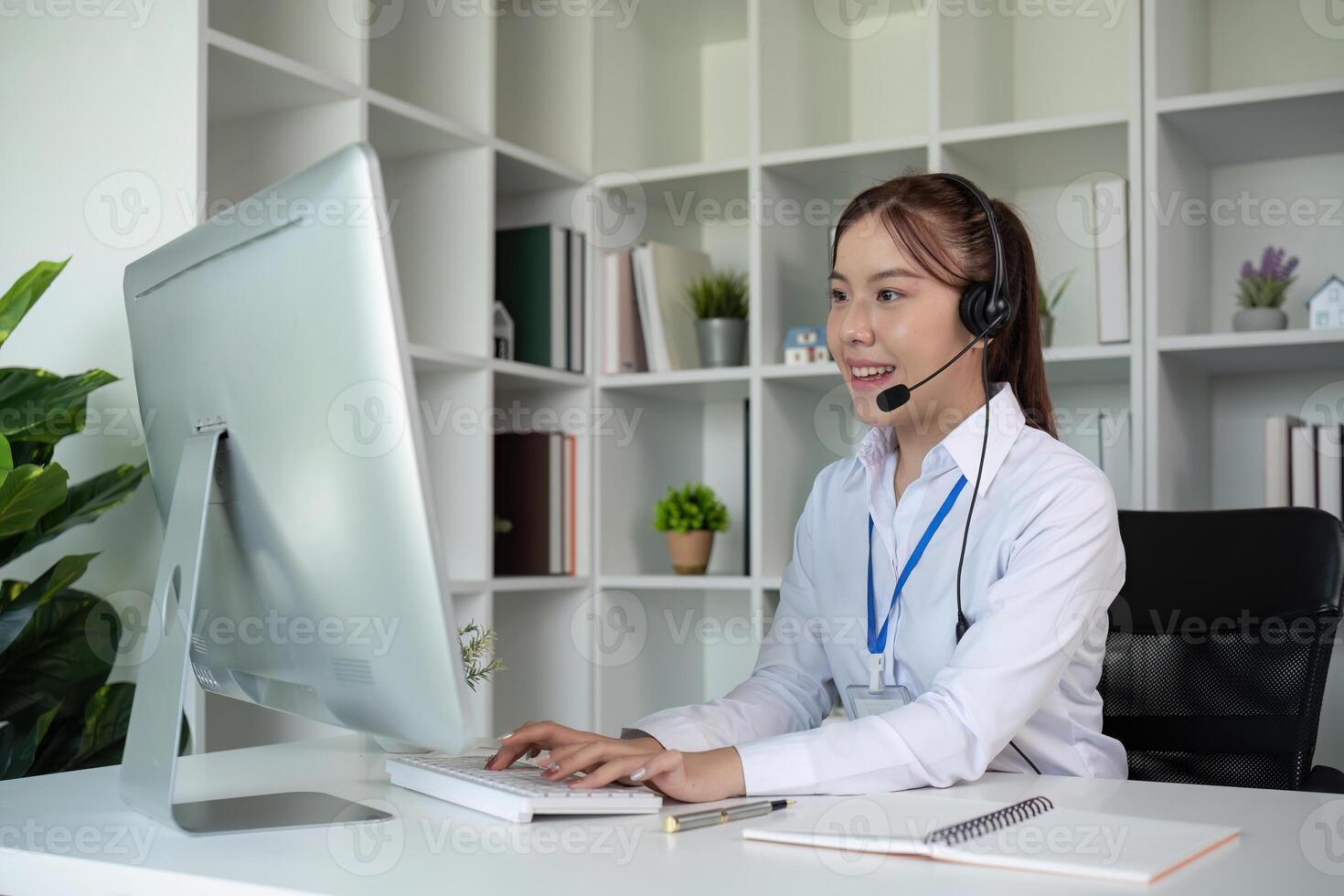 Call center agents wear headphones to talk to customers. Provide consultation via online channels on laptops photo