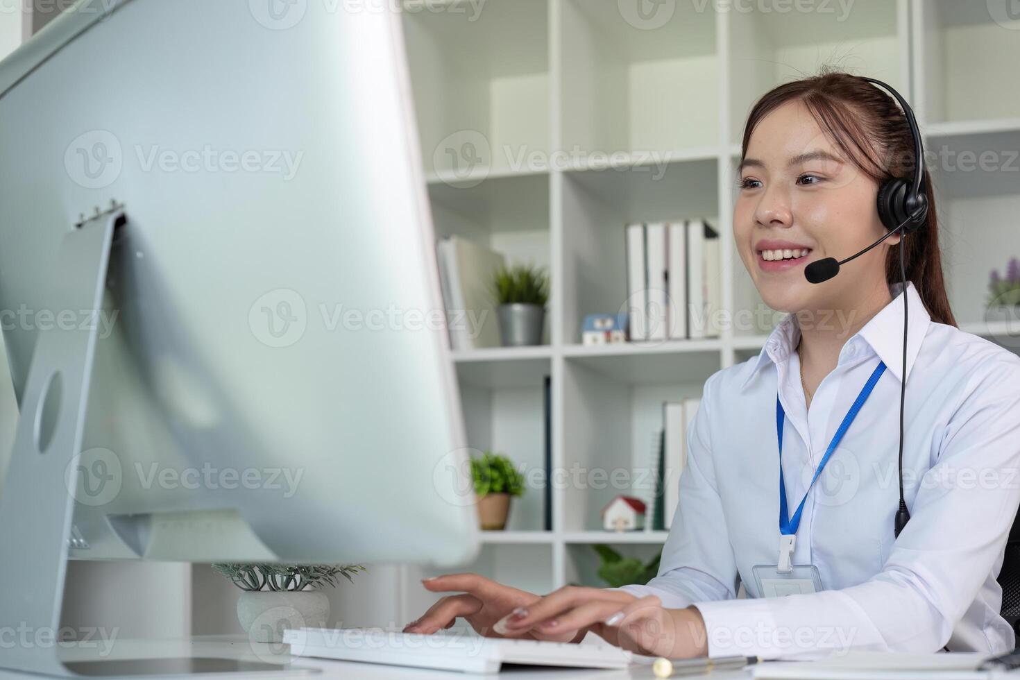 Call center agents wear headphones to talk to customers. Provide consultation via online channels on laptops photo