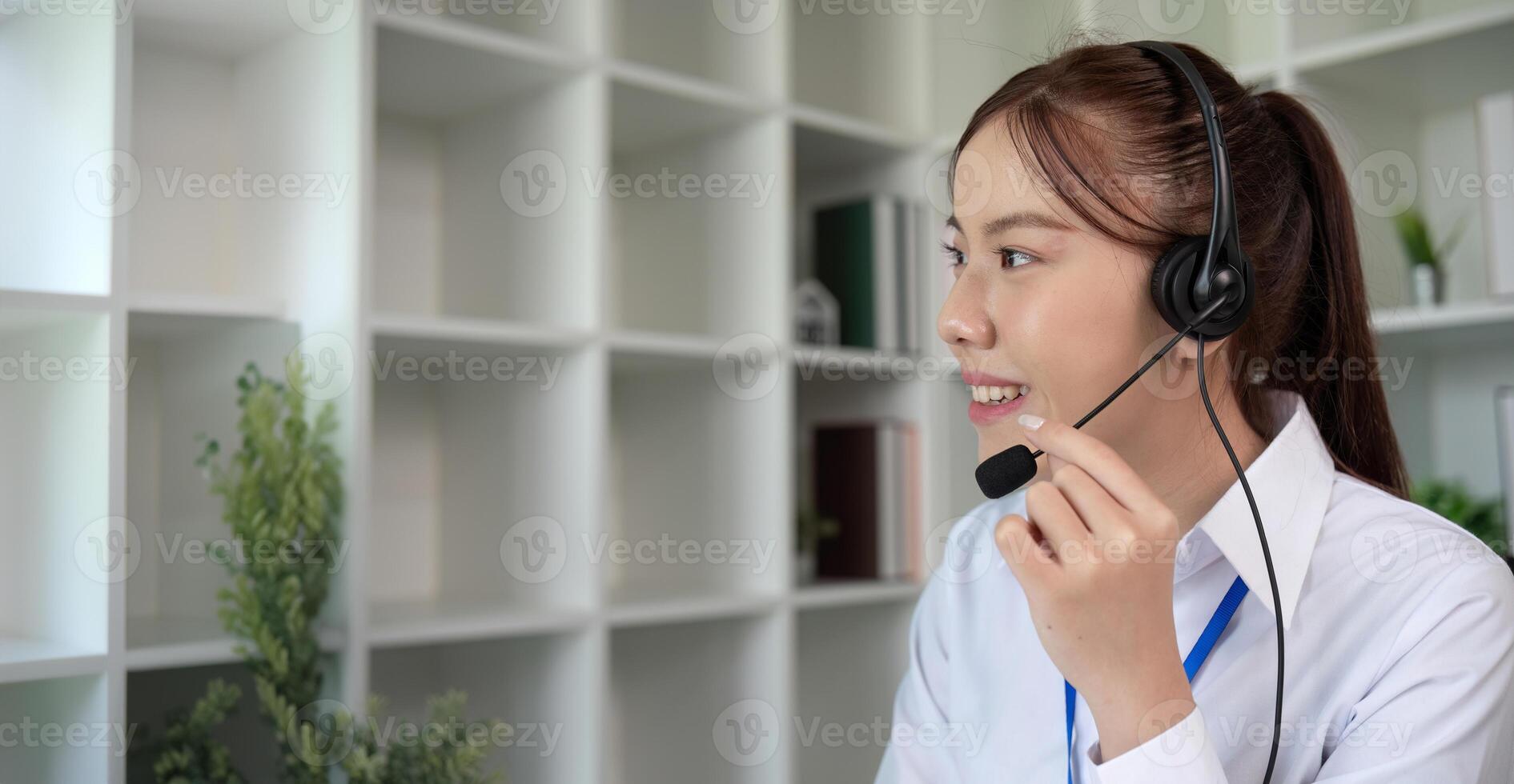 Call center agents wear headphones to talk to customers. Provide consultation via online channels on laptops photo