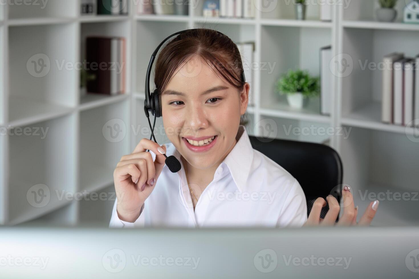 Call center agents wear headphones to talk to customers. Provide consultation via online channels on laptops photo