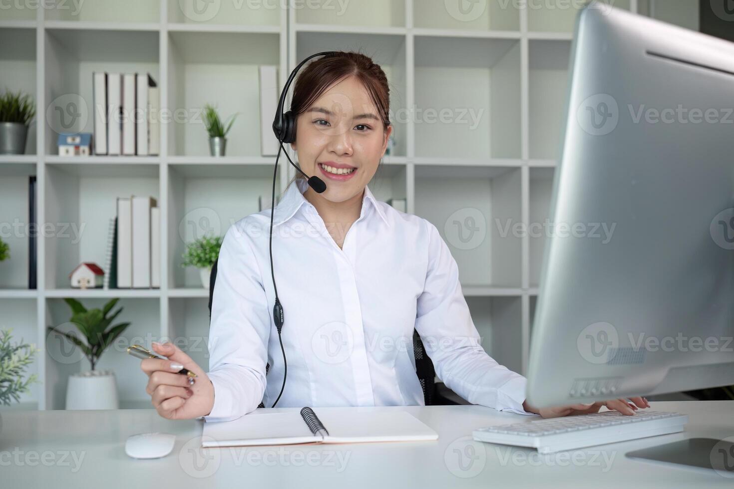 Call center agents wear headphones to talk to customers. Provide consultation via online channels on laptops photo