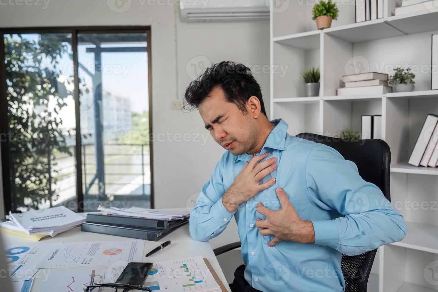 Overcoming health problems through hard work a businessman's struggle in a office environment photo