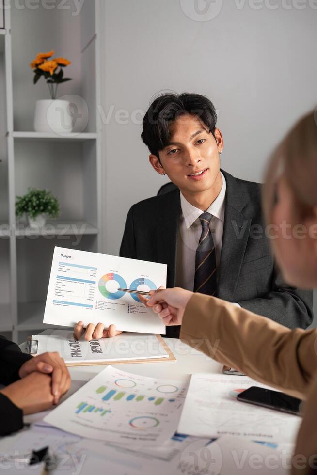 Business Team Collaborates on Data Analysis with Graphs and Charts in Modern Office Setting photo