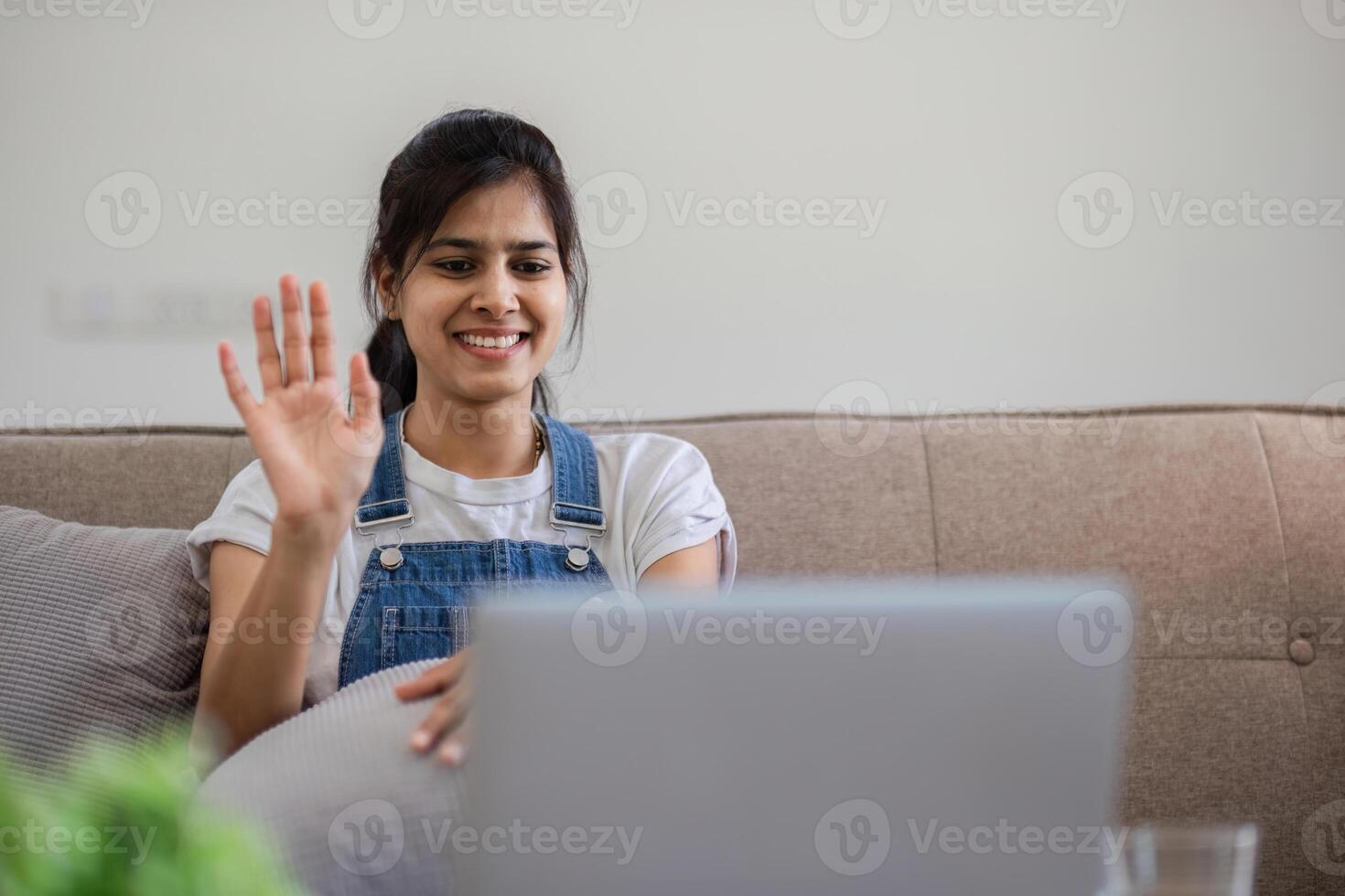 Woman Engaged in Call from Cozy Living Room Setting with Modern Decor and Comfortable Ambiance photo
