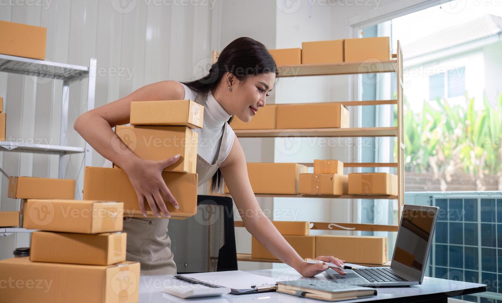 SME business entrepreneurs small in asia Preparing cardboard boxes in home office Small business operators preparing to ship to customers photo
