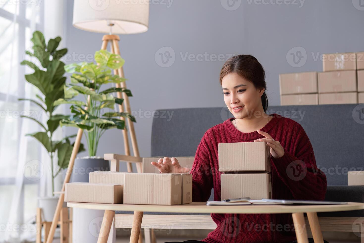 SME business entrepreneurs small in asia Preparing cardboard boxes in home office Small business operators preparing to ship to customers photo