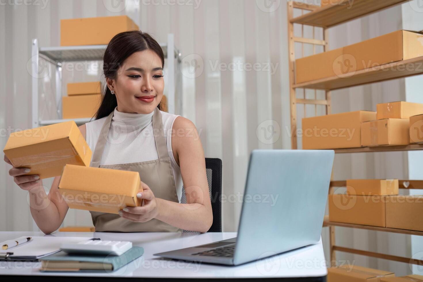 SME business entrepreneurs small in asia Preparing cardboard boxes in home office Small business operators preparing to ship to customers photo