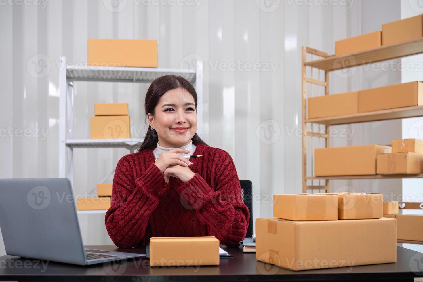 SME business entrepreneurs small in asia Write shipping information on a cardboard box in my home office. Small business operators preparing to ship to customers photo