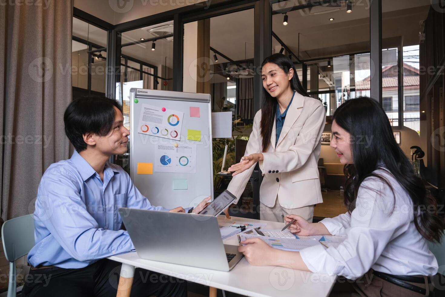 Business team meeting where the team leader is presenting a work plan graph. Discuss and summarize work results in the conference room. photo