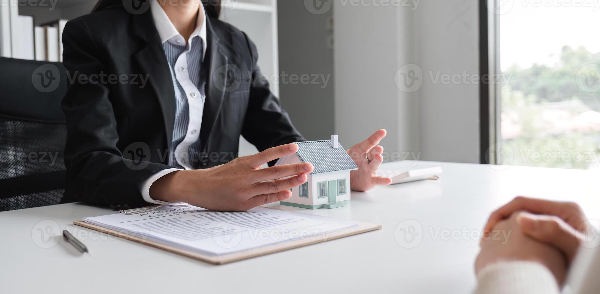Couple Signing Real Estate Sales Contract in Modern Office Setting with Agent Present, Symbolizing New Home Purchase and Property Investment photo