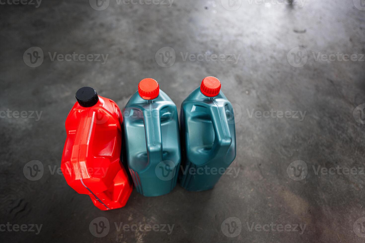 Plastic jugs with colorful caps on a concrete floor photo