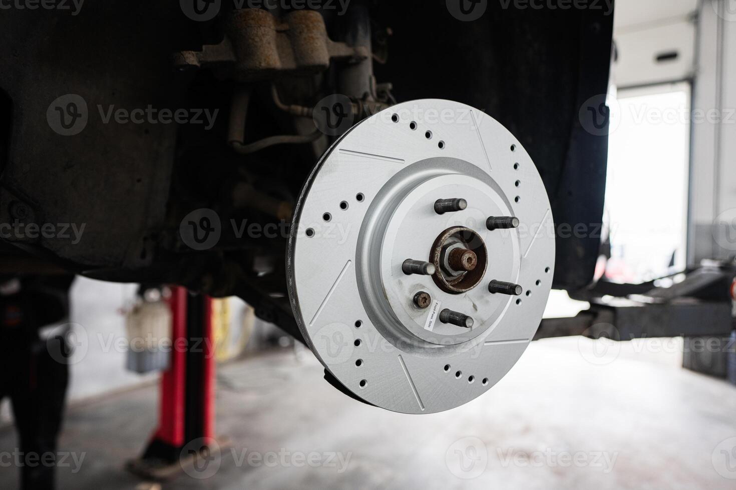 Close-up of car brake disc in an auto repair shop photo