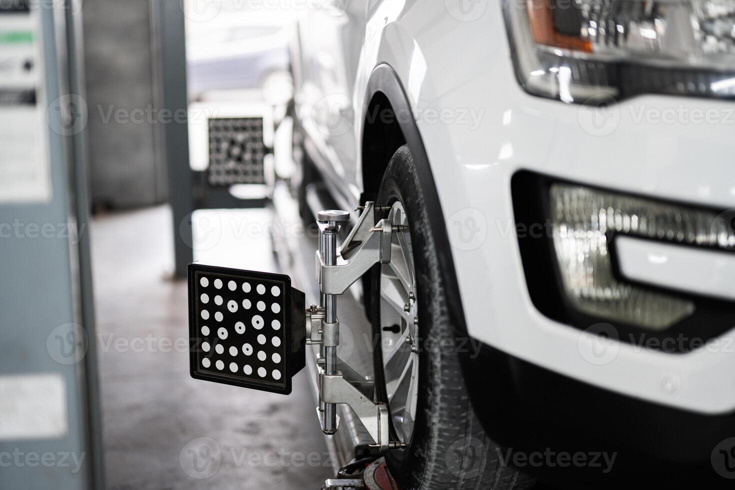 Close up of car wheel alignment in auto repair shop photo