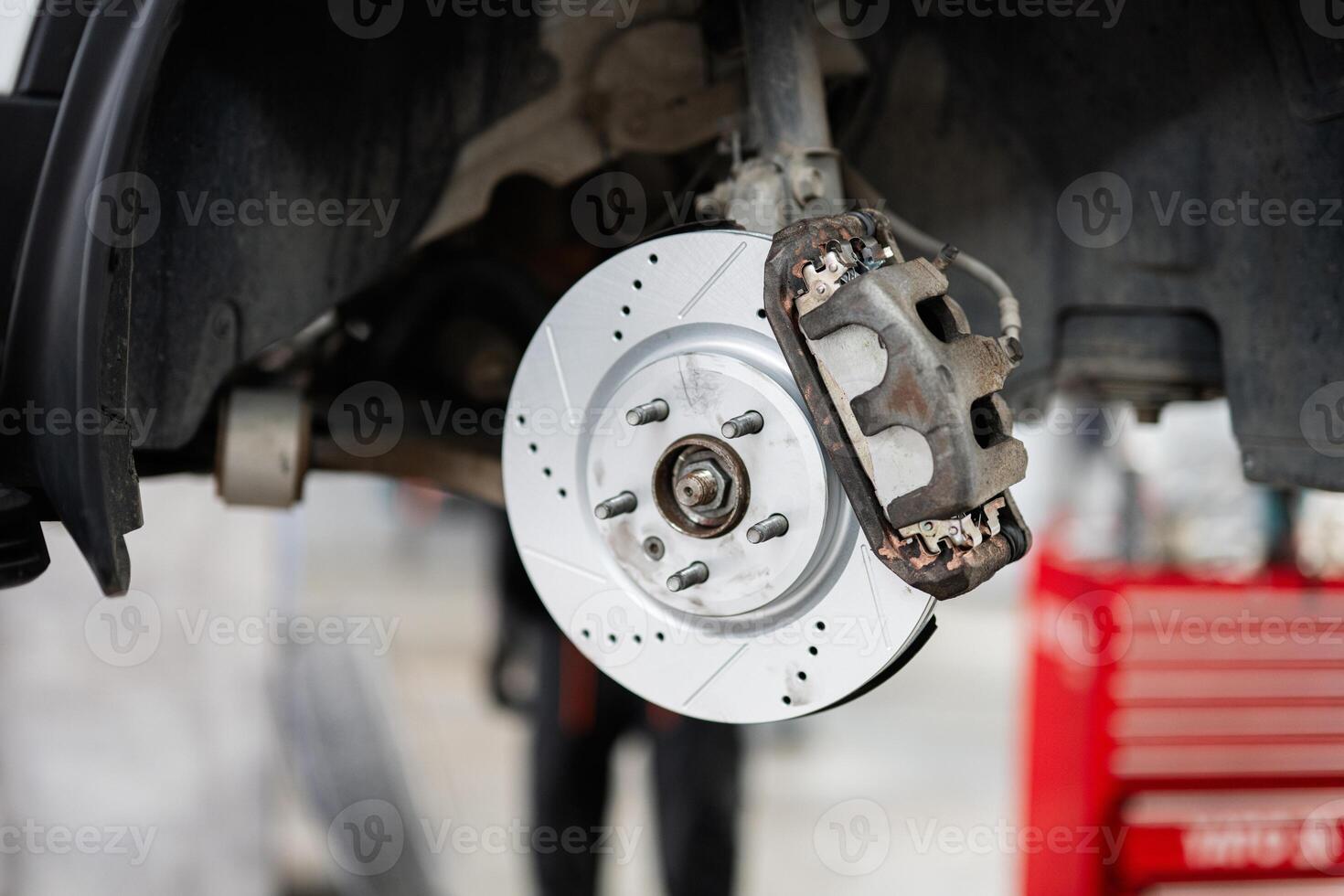 Close-up of a car brake system in an automotive workshop photo