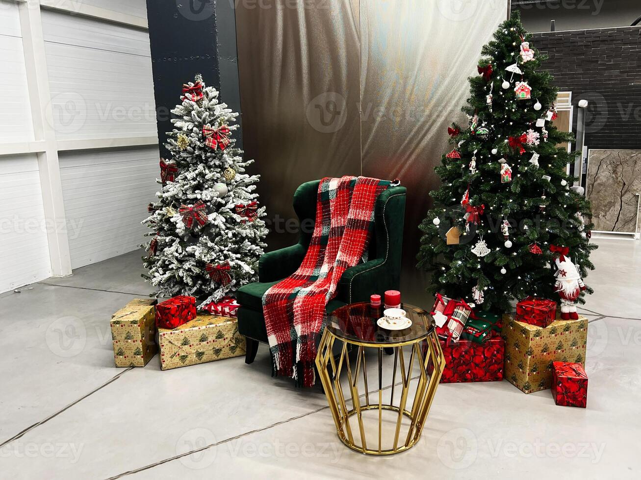 Cozy Christmas setting with trees, gifts, and a comfortable armchair photo