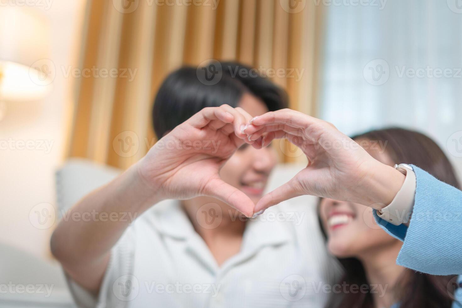 Young couple make heart shape for love together, Couple hands making heart shape photo