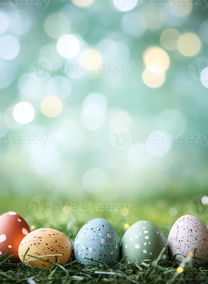Colorful easter eggs lying on green grass with bokeh lights in background photo