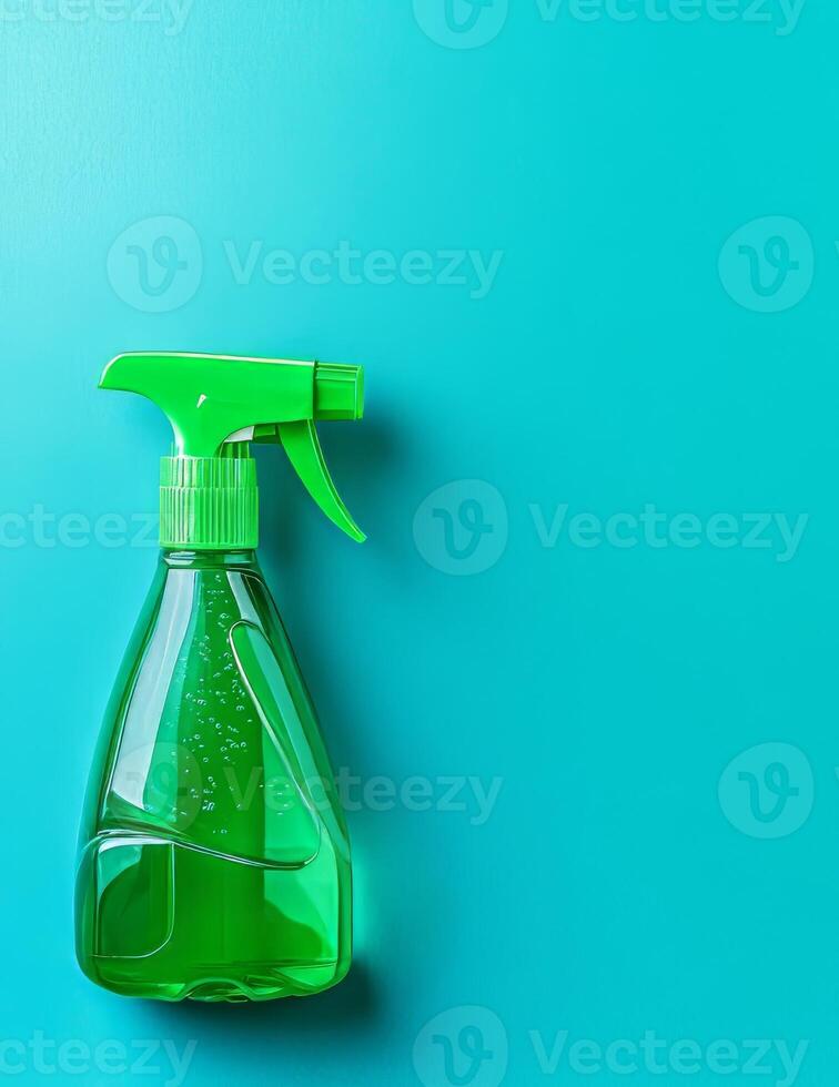 Cleaning spray bottle on turquoise background photo