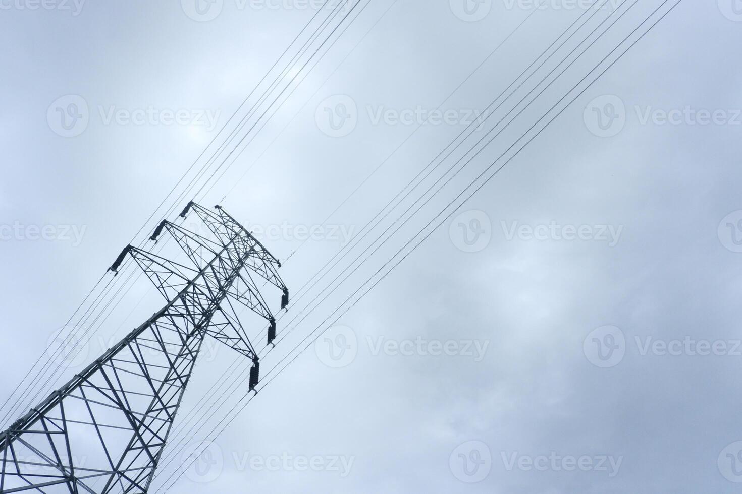 An electric power line against a cloudy sky photo