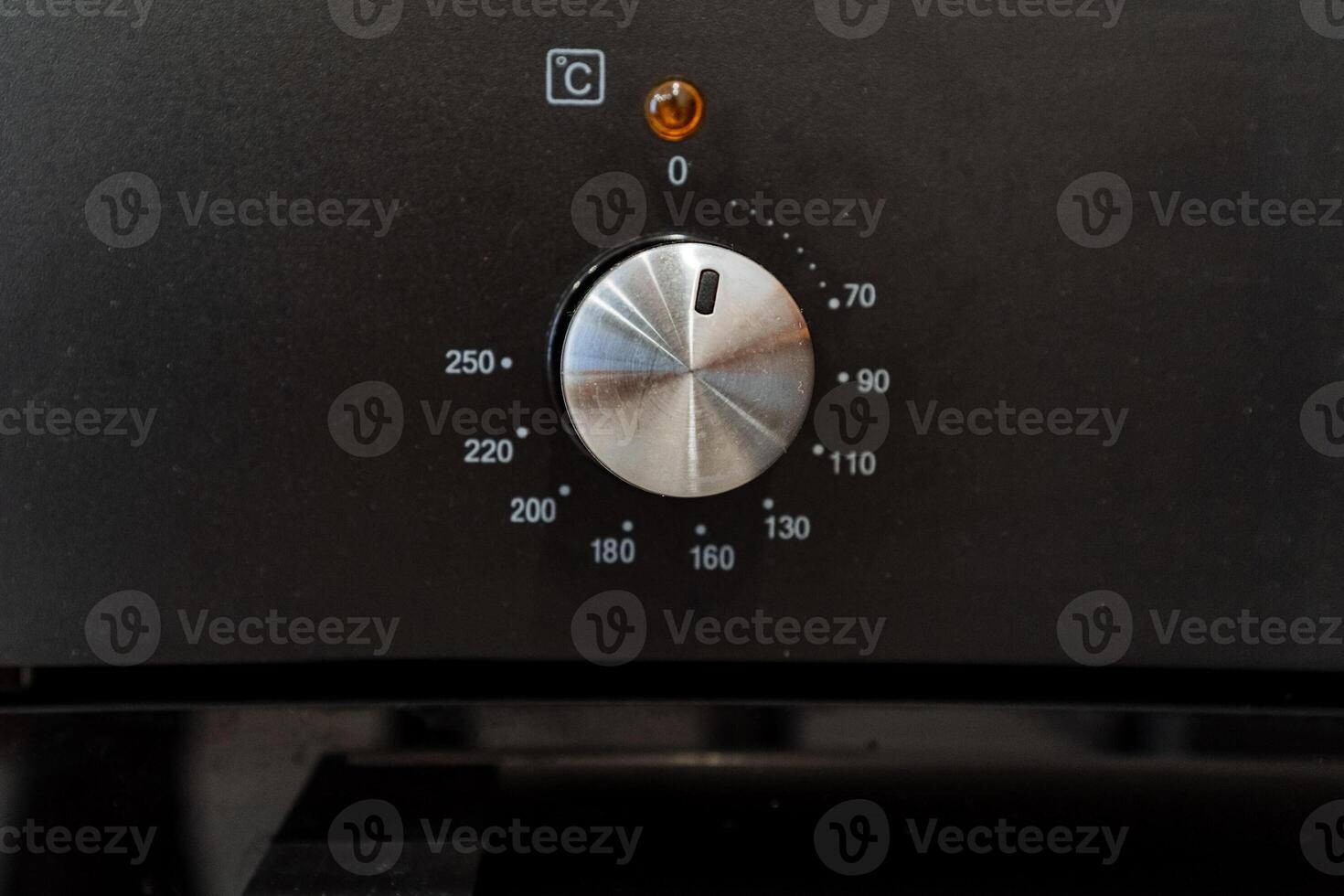 a close up of a knob on a black appliance photo