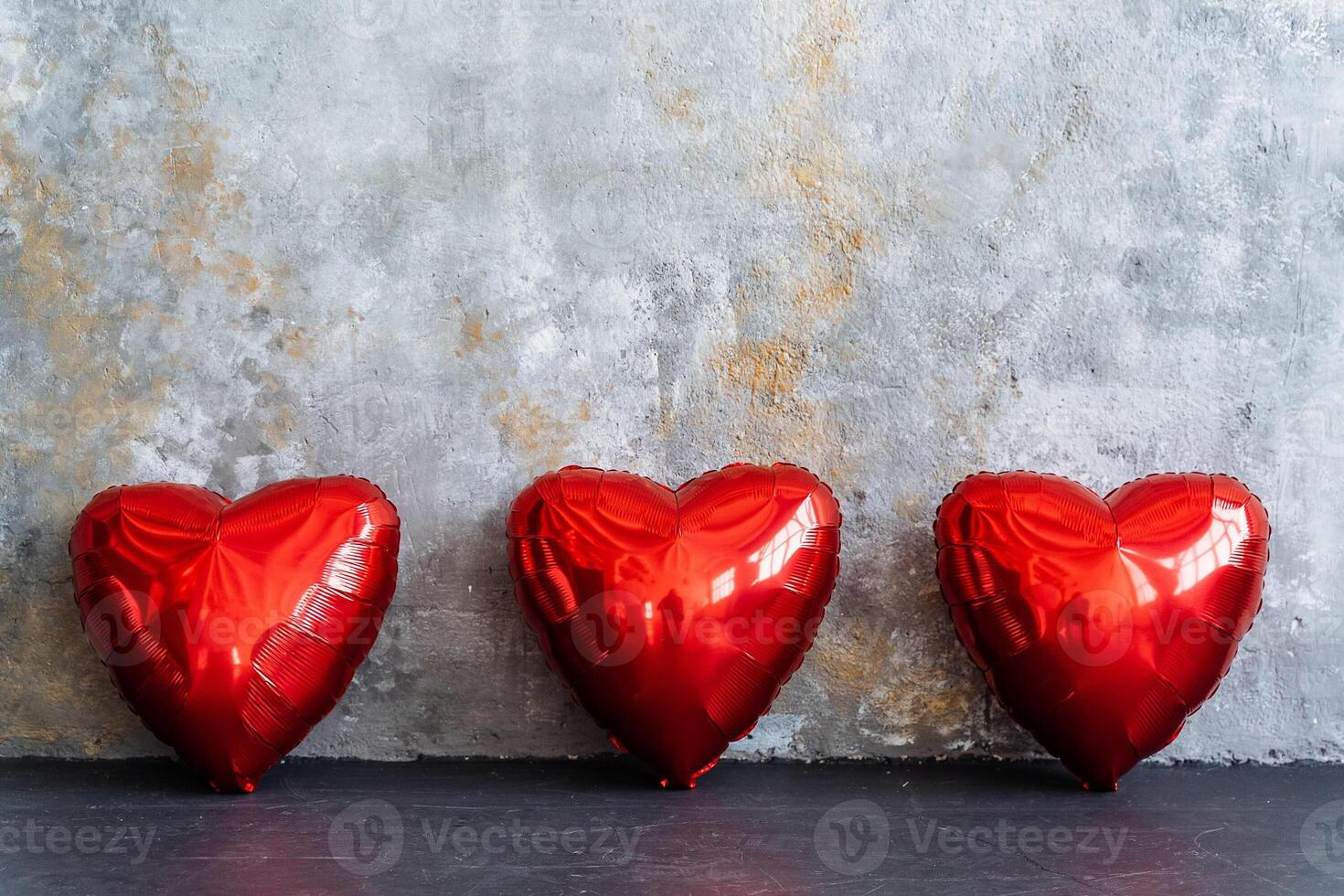 Three sweet red hearts are grouped together on the table photo