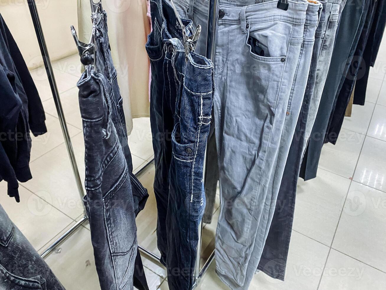 Store your denim and sportswear on a jeans hanging rack, keeping them organized from waist to thigh with electric blue sleeves. photo