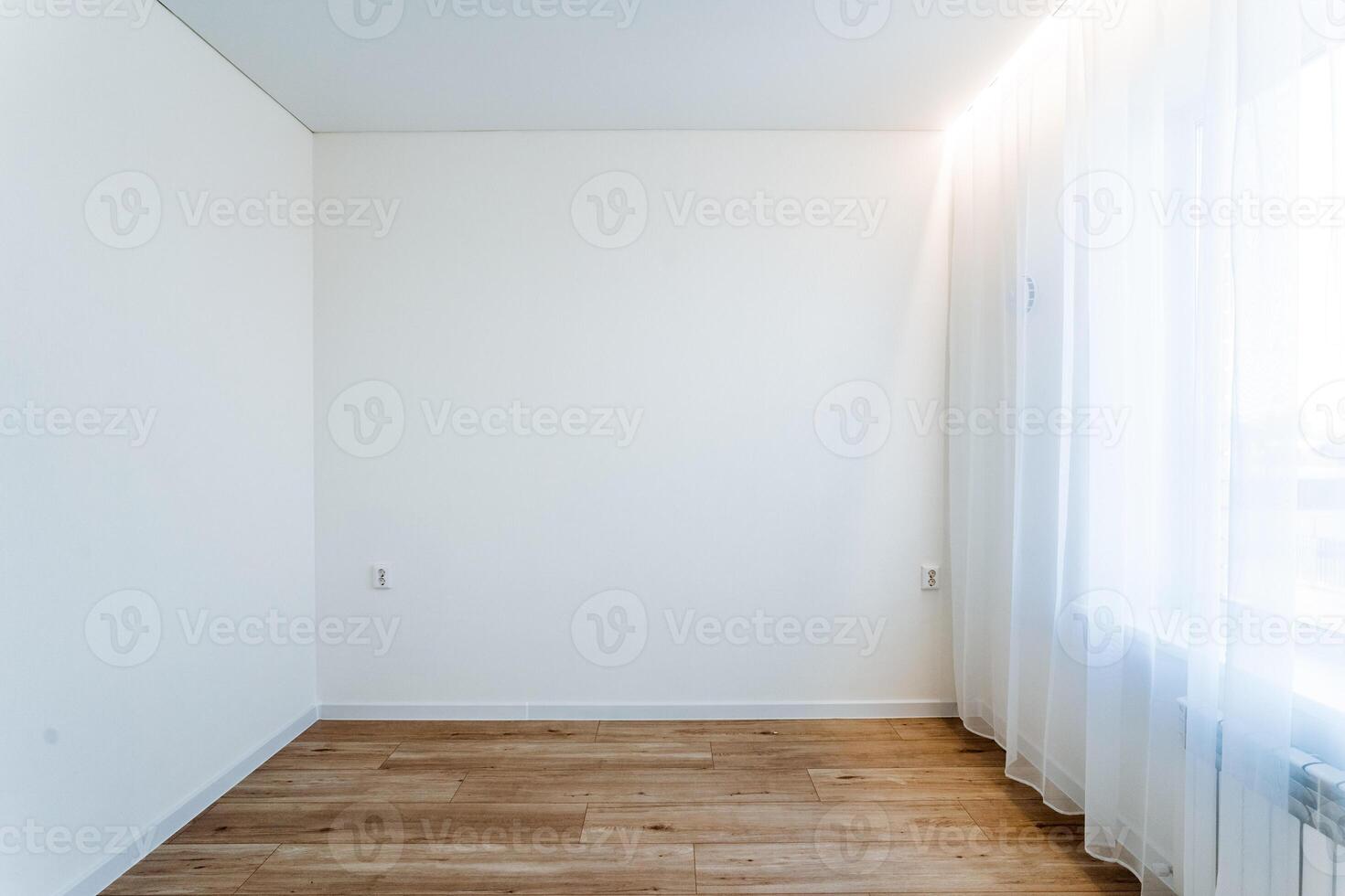 A minimalist room with wooden floor and sheer curtains, clean lines and modern design creates a tranquil and uncluttered interior with a bright, serene atmosphere photo