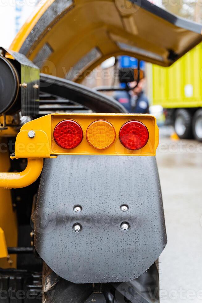 Yellow vehicle stopped with open hood for maintenance photo
