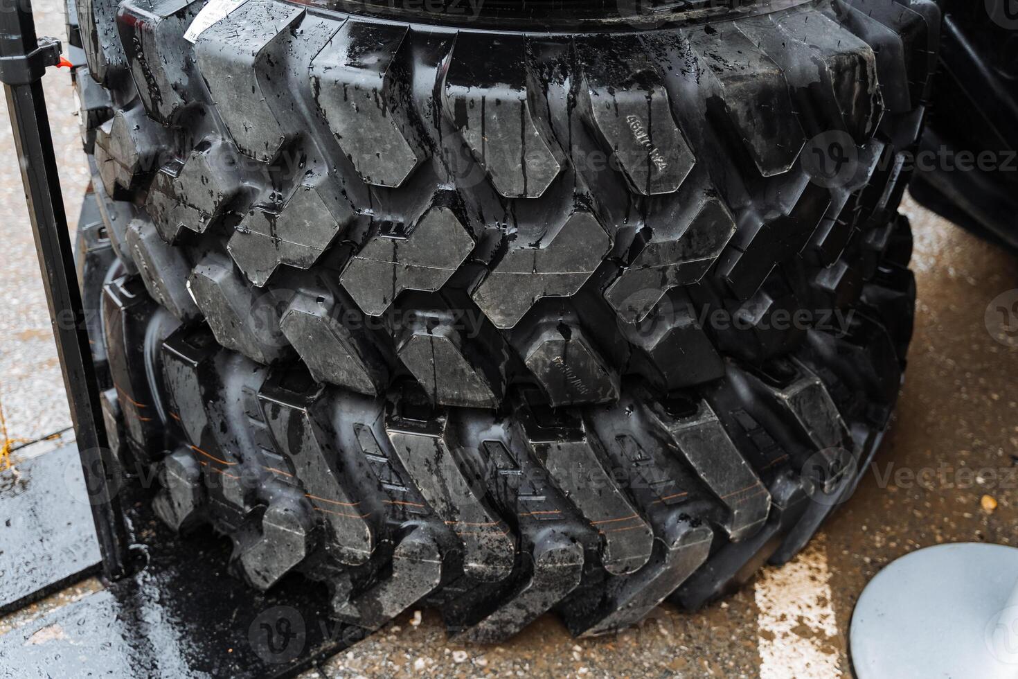 Two tires stacked one on top of the other on the ground photo