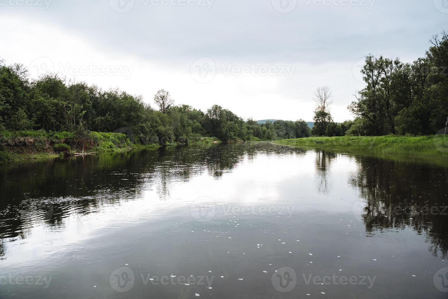Picturesque and serene, this river landscape boasts lush greenery and calm waters, offering a tranquil environment in natures embrace for relaxation and reflection photo