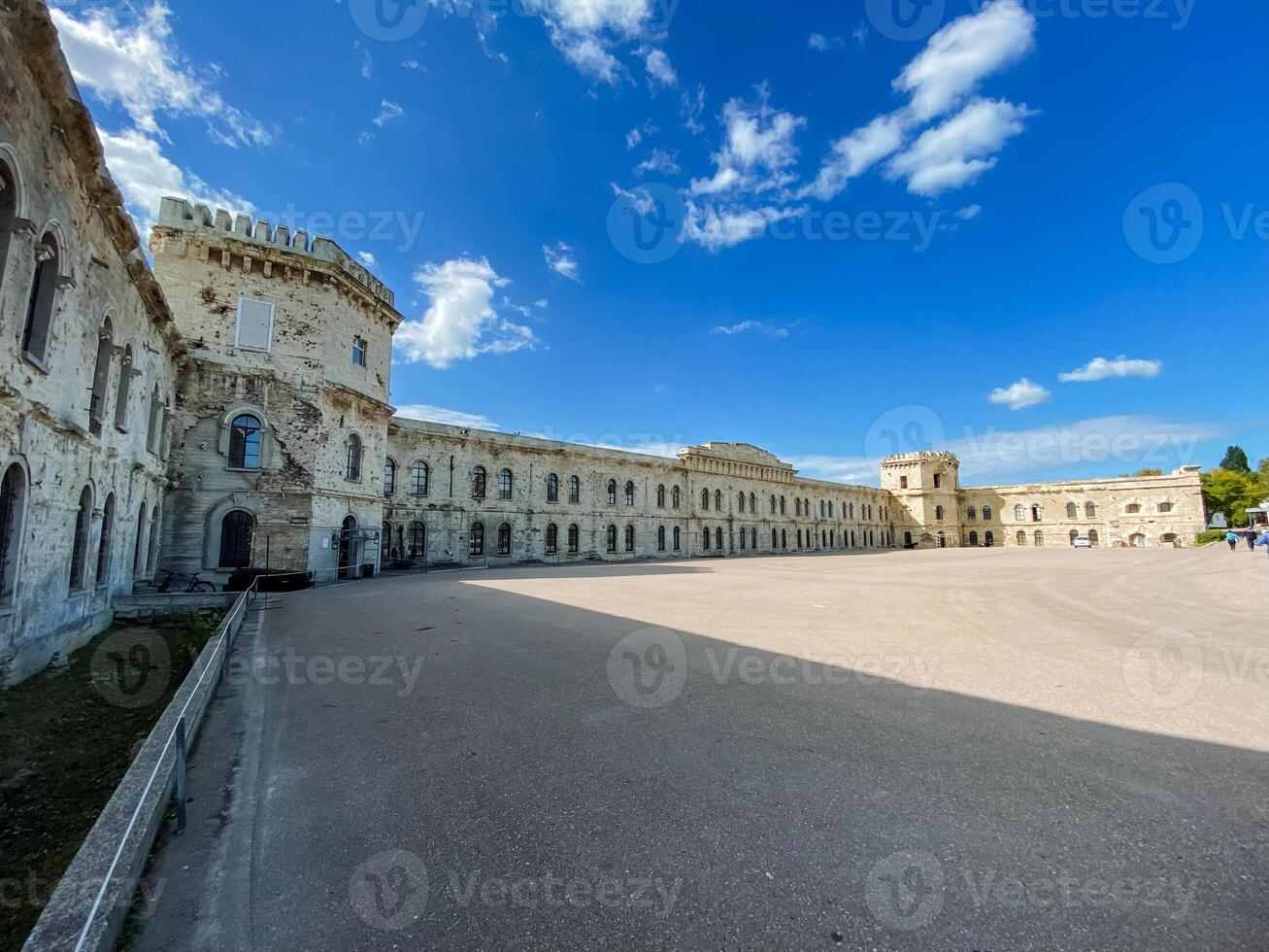 A large and impressive building stands majestically with a brilliant blue sky in the background, adding to its beauty and grandeur, setting the scene for a noteworthy view photo