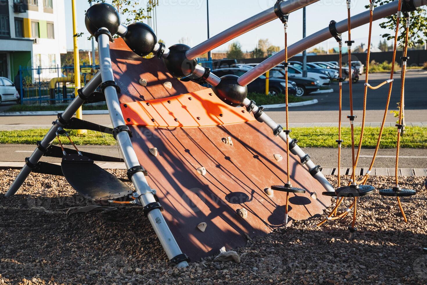 This lively and vibrant playground serves as a delightful haven for children, featuring a sturdy wooden slide, robust climbing ropes, and ample space for adventurous and imaginative play photo