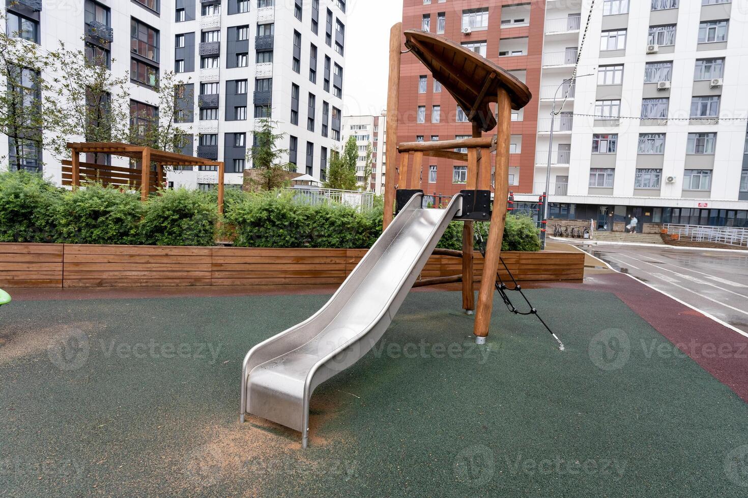 A contemporary playground slide designed for urban environments, featuring safety enhancements for children photo