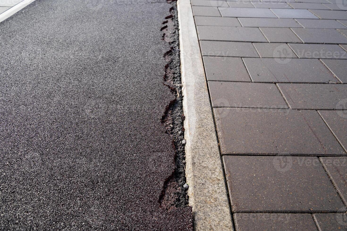 The damaged sidewalk resulting from significant ground movement has a notable impact on urban infrastructure photo