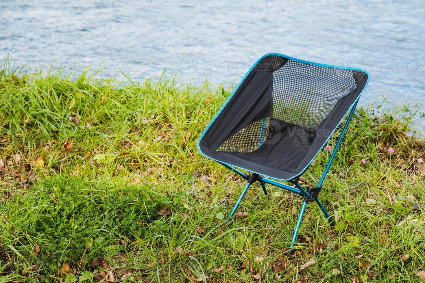 Experience the outdoors with a Compact Portable Camping Chair for ultimate comfort while relaxing by the river during your adventures photo