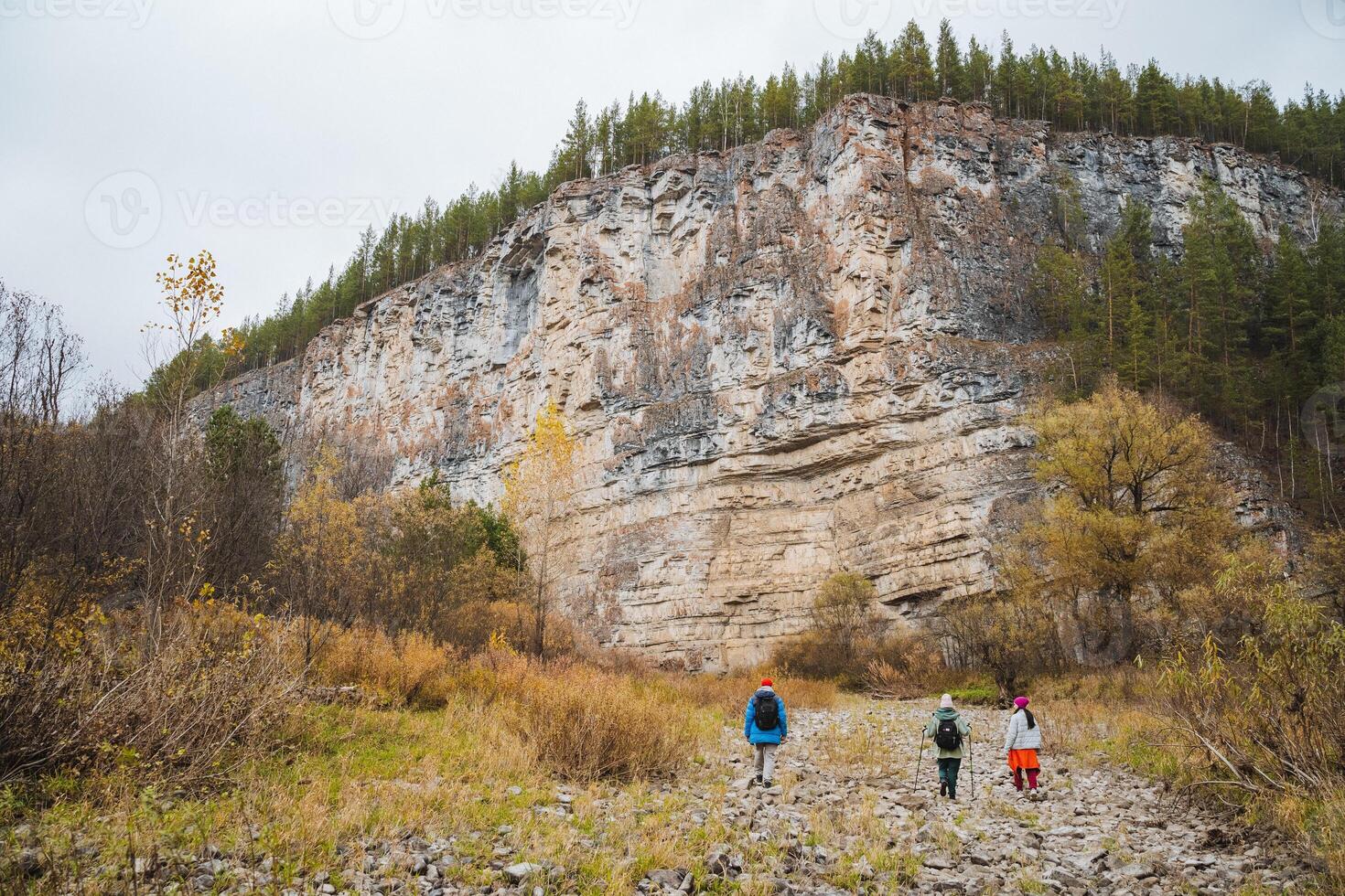 Hikers set off on a thrilling and adventurous journey through rugged terrain while exploring the majestic cliffs found in the scenic wilderness photo