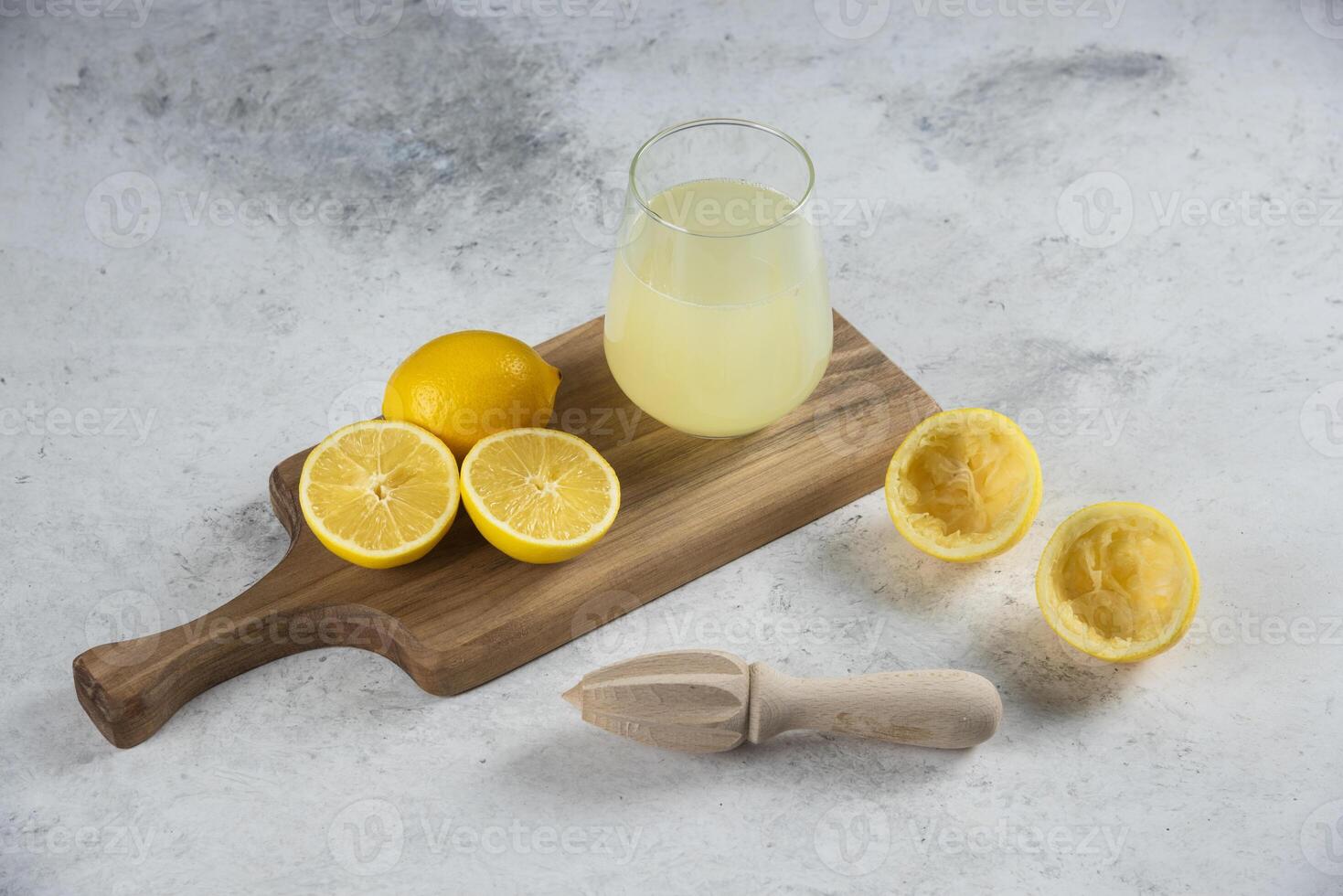 lemon juice on a wooden board with a knife and a lemon photo