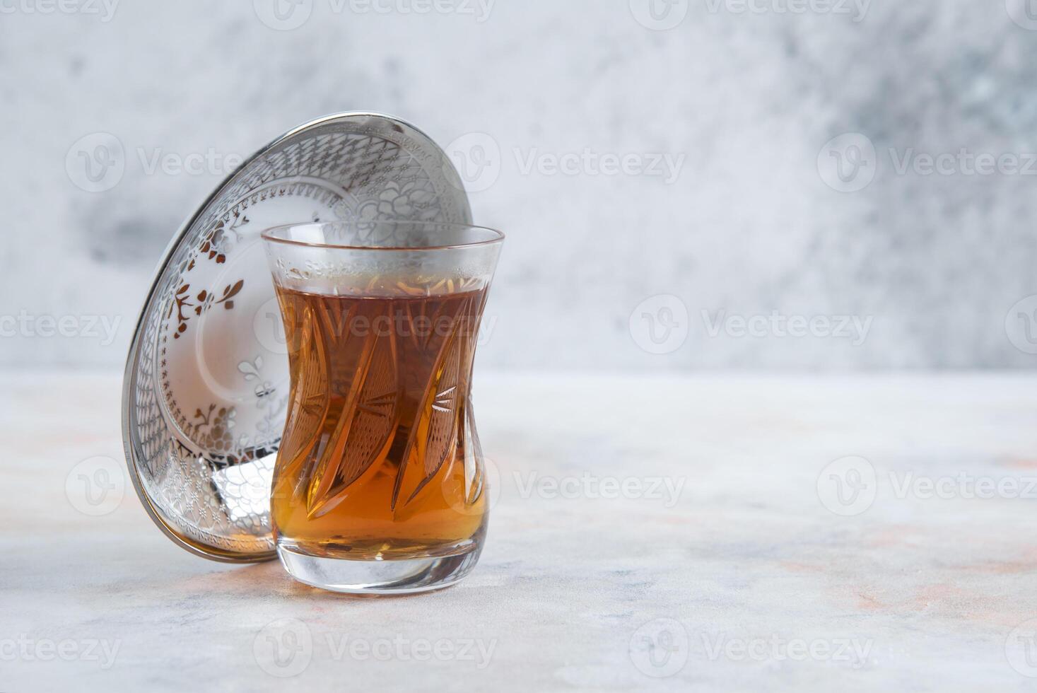 Glass of tea on white background photo