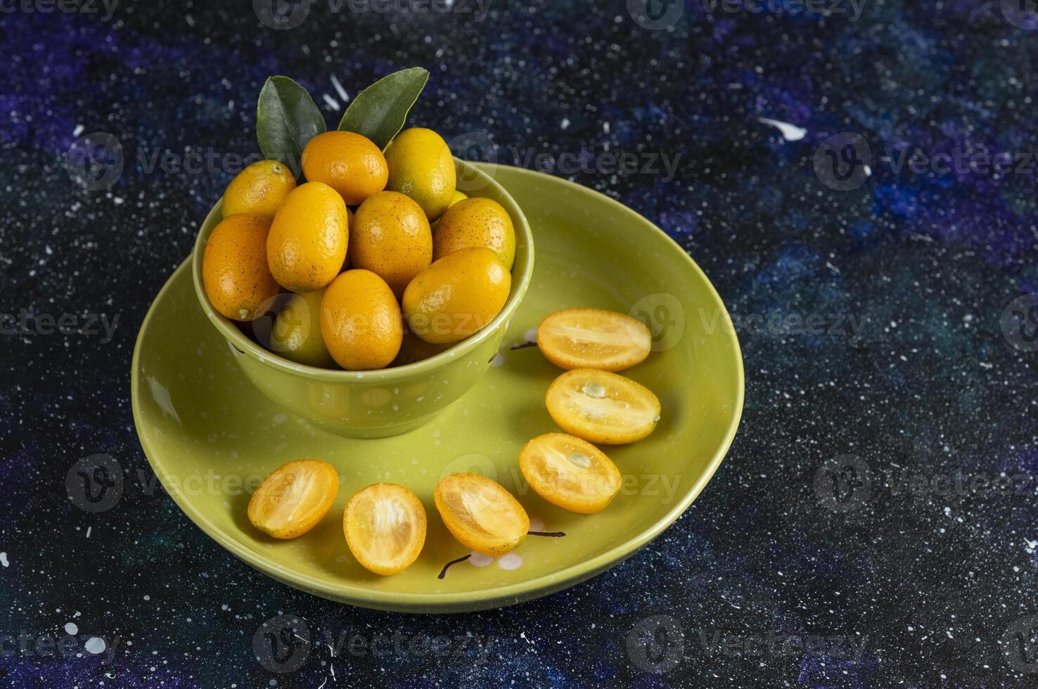 Fresh organic kumquats whole or half cut photo